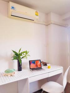 a white desk with a laptop on top of it at Near old city,Nimman,Night Barzaa swimming pool apartment 26 in Chiang Mai