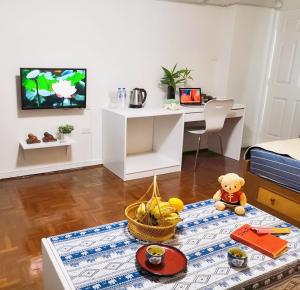 a living room with a table with a basket of fruit at Near old city,Nimman,Night Barzaa swimming pool apartment 26 in Chiang Mai