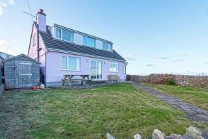 a house with a picnic table in front of it at Spin Drift in Cemaes Bay