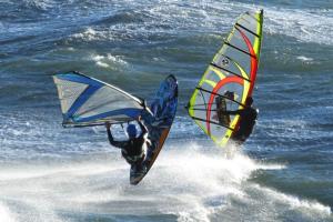 two people are windsurfing on the ocean at T2 Magnifique vue mer panoramique in Six-Fours-les-Plages