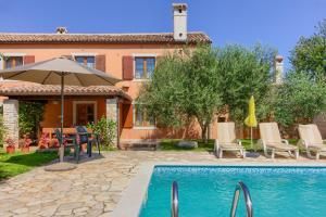 a villa with a swimming pool and a house at Beautiful stone istrian villa Anamaria with pool near the beach in Šišan