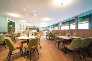 a dining room with tables and chairs in a restaurant at Hotel Aurlandsfjord in Aurland