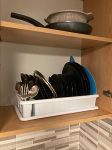 a tray of plates and utensils on a shelf at Bacio di Dama in Milan