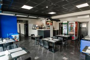 ein Restaurant mit Tischen und Stühlen in einem Raum in der Unterkunft AF TRANS Hotel in Mahala