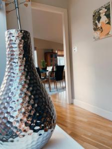 a vase filled with wine bottles sitting on a table at Apartment 11 Popeshead Court in York