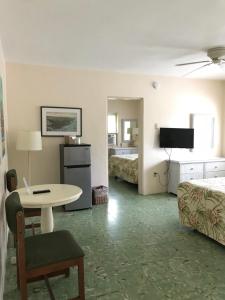 ein Hotelzimmer mit einem Tisch und einem Bett in der Unterkunft El Patio Motel in Key West