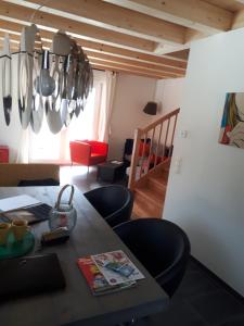 a dining room with a table with chairs and utensils at Casa Kümpel in Arnoldstein +24 photos