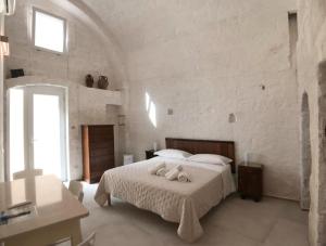 a bedroom with a bed with two towels on it at Palazzo Enselmi in Matera