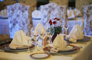 a table with wine glasses and napkins on it at Logis Le Relais Imperial in Saint-Vallier-de-Thiey