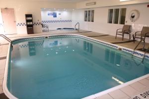 a large swimming pool with blue water in a building at Comfort Inn Wichita Falls Near University in Wichita Falls