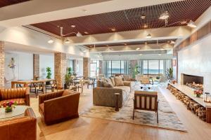 a living room with furniture and a fireplace at Delamar Traverse City in Traverse City