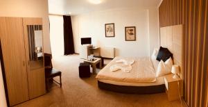 Postel nebo postele na pokoji v ubytování Hotel Mon Caprice