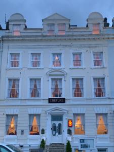 a white building with a sign on it at THE TREVONE, Llandudno in Llandudno