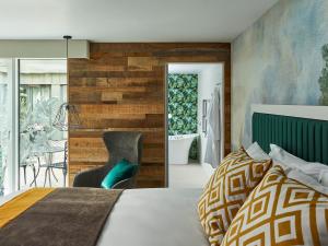 a bedroom with a bed and a wall of wood at Hotel Indigo - Bath, an IHG Hotel in Bath