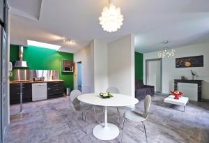 a kitchen and a living room with a table and chairs at Appartements Rue Lemoine XXL in Angers