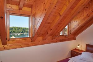 a bedroom with a large window in a log cabin at Villa Sole in Cavtat