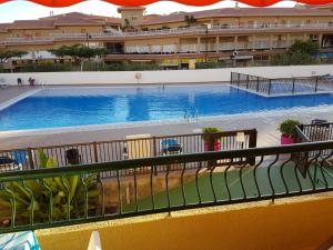 a view of a swimming pool from a balcony at PLAYA LAS VISTAS LOFT in Los Cristianos