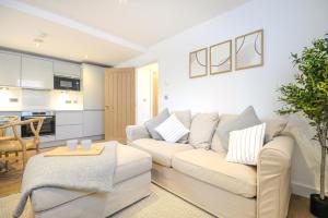 a living room with a white couch and a table at Concorde House Luxury Apartments - Chester in Chester