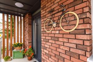 a bike hanging on the side of a brick wall at TamTam Urban in Cluj-Napoca