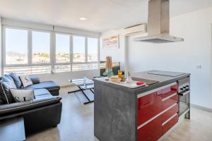 a kitchen with a red island in a living room at Beach Suite, city & mountain view in Alicante