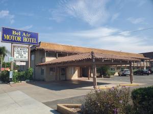 a building with a sign for a motel at Bel Air Motor Hotel in Tustin