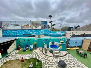 a room with a large mural on the side of a building at Galápagos Eco Friendly in Puerto Baquerizo Moreno