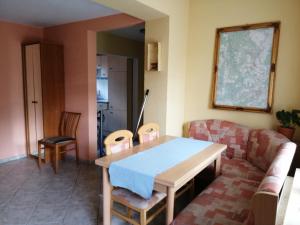 a living room with a table and a couch at Ferienhaus Pauline am See in Müllrose