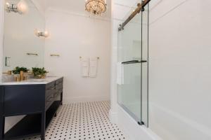 a bathroom with a shower, sink, and toilet at 20 South Battery in Charleston