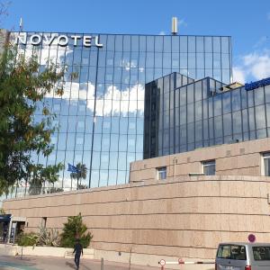 a large building with a clock on the side of it at Novotel Nice Arenas Aeroport in Nice