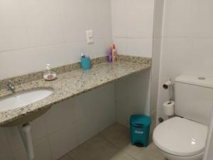 a bathroom with a sink and a toilet at Casa paraíso 2 in Arraial do Cabo +21 photos