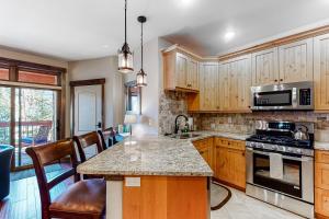 a kitchen with wooden cabinets and a counter top at Frisco Frolic in Frisco