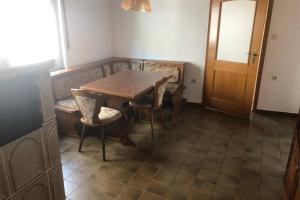 a dining room with a wooden table and chairs at room for four in Alzenau in Unterfranken