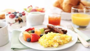 a plate of breakfast food on a table at Holiday Inn Chicago Nw Crystal Lk Conv Ctr, an IHG Hotel in Crystal Lake