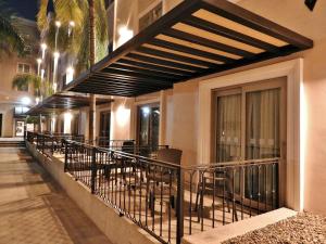 a balcony with tables and chairs on a building at Holiday Inn Reynosa Zona Dorada by IHG in Reynosa