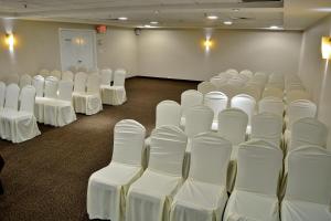 a room with rows of white chairs in it at Holiday Inn Reynosa Zona Dorada by IHG in Reynosa +65 photos