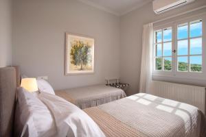 Postel nebo postele na pokoji v ubytování Villa Corfu Melody