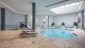 a large pool in a room with lounge chairs at Holiday Inn Panama City by IHG in Panama City