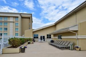 a building with benches in front of a building at Holiday Inn Martinsburg, an IHG Hotel in Martinsburg