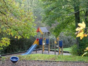 a playground with a slide in a park at Au repaire des écureuils in Waulsort