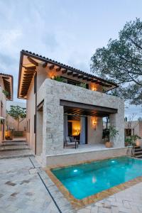a house with a swimming pool in front of a house at Hotel Casa Santo Origen in Oaxaca City