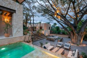 a backyard with a swimming pool and a tree at Hotel Casa Santo Origen in Oaxaca City +42 photos