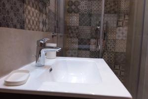 a bathroom with a sink and a shower at Casa Ferdinando apartment in Naples