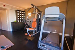 a room with a gym with a treadmill at Aiden by Best Western at Paris Roissy CDG in Roissy-en-France