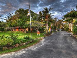 a street with a flag on the side of the road at Anchorage Holiday Park in Iluka