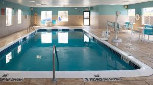 een zwembad met blauw water in een gebouw bij Holiday Inn Express Hotel & Suites Chester, an IHG Hotel in Chester
