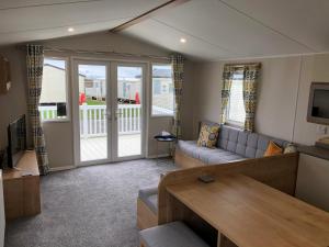 a living room with a couch and a table at Whitley bay 4 berth Luxury Caravan in Newcastle upon Tyne