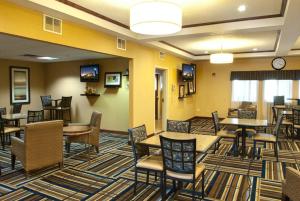 a lobby with tables and chairs in a hotel at Holiday Inn Express - Canyon, an IHG Hotel in Canyon