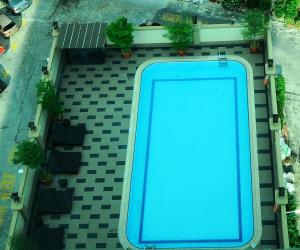 an overhead view of a blue swimming pool on a patio at The Katerina Hotel in Batu Pahat