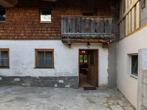 a building with a wooden door and a balcony at Lovely Holiday Home in Rauris with Terrace in Rauris