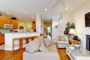 a living room with a couch and a kitchen at Bear Trap Dunes - 1 Village Green in Ocean View